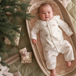 A baby wearing a sleepsuit in winter ski design