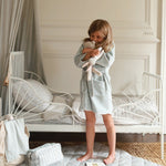 A girl wearing towelling robe quail while playing