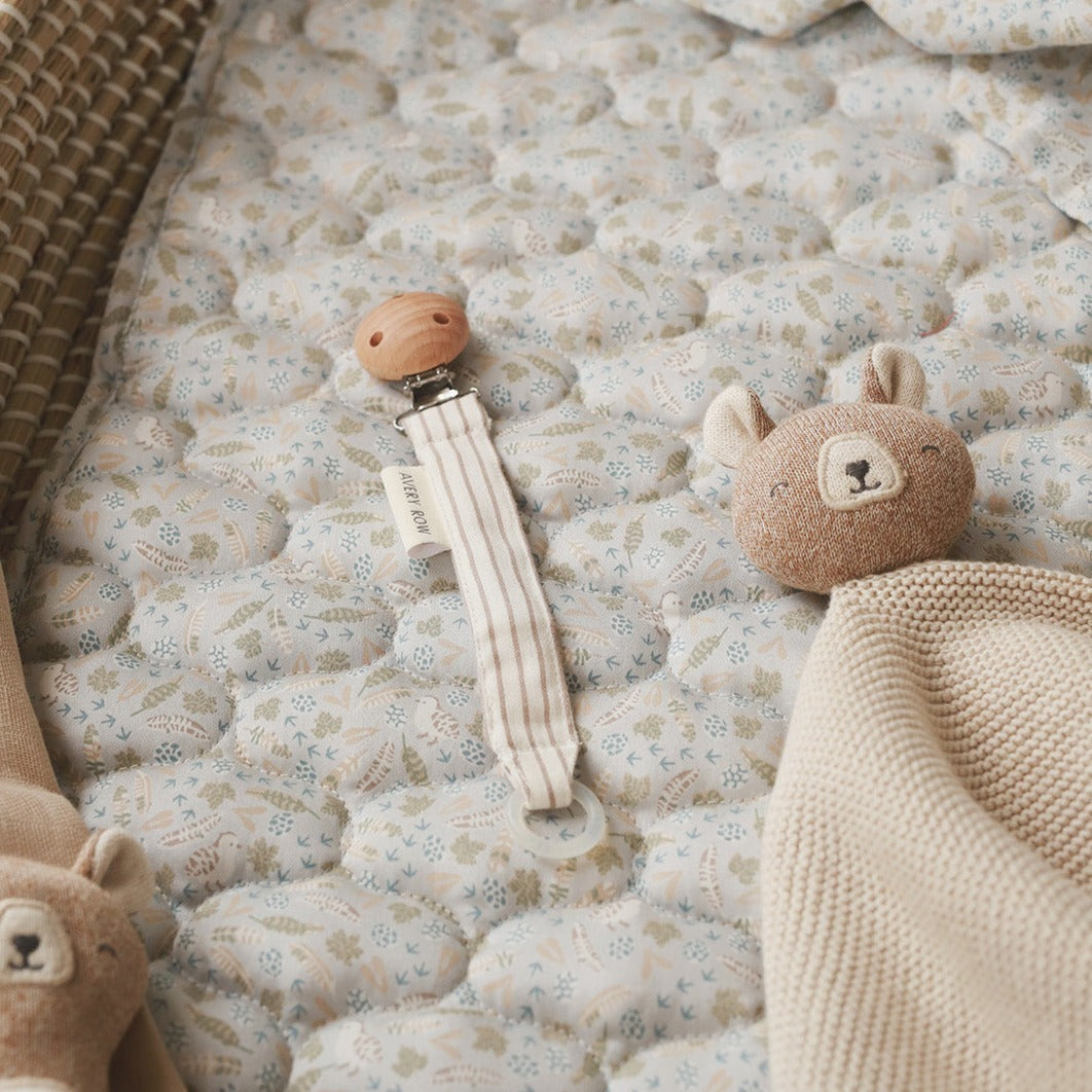 Cute pacifier holder on top of cotton liner nature trail