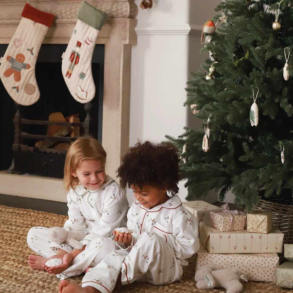 Kids both on pyjamas sitting and playing