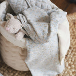 Nature trail swaddles on a storage basket