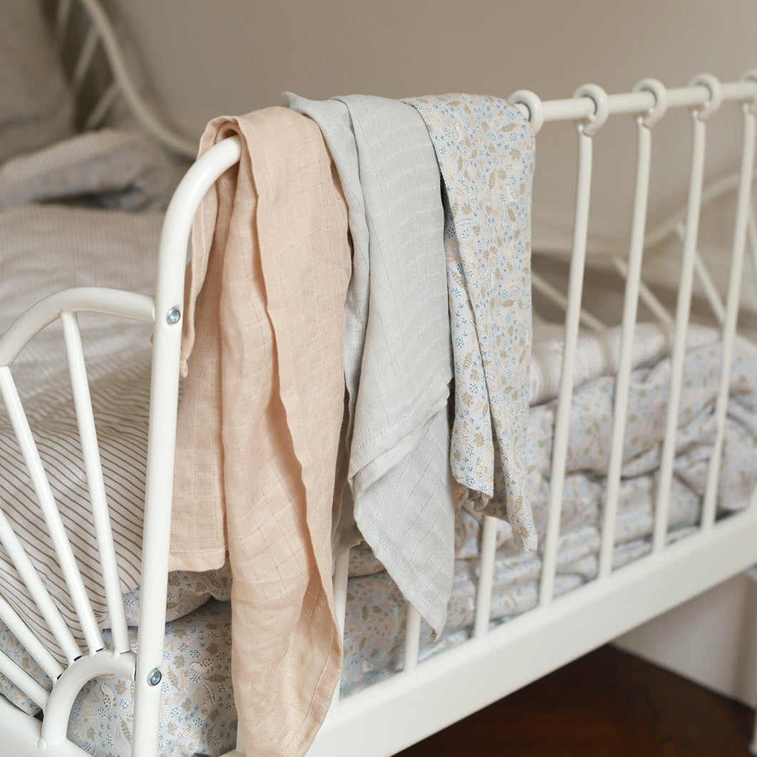 Nature Trail Muslin Squares on a bed