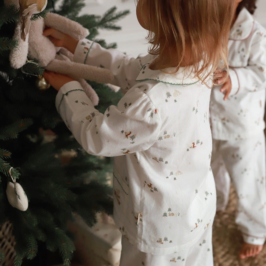 Two girls wearing Christmas pyjamas