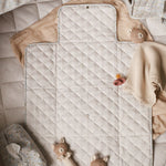 Teddies and baby wipes cover placed on top of travel changing mat nature trail